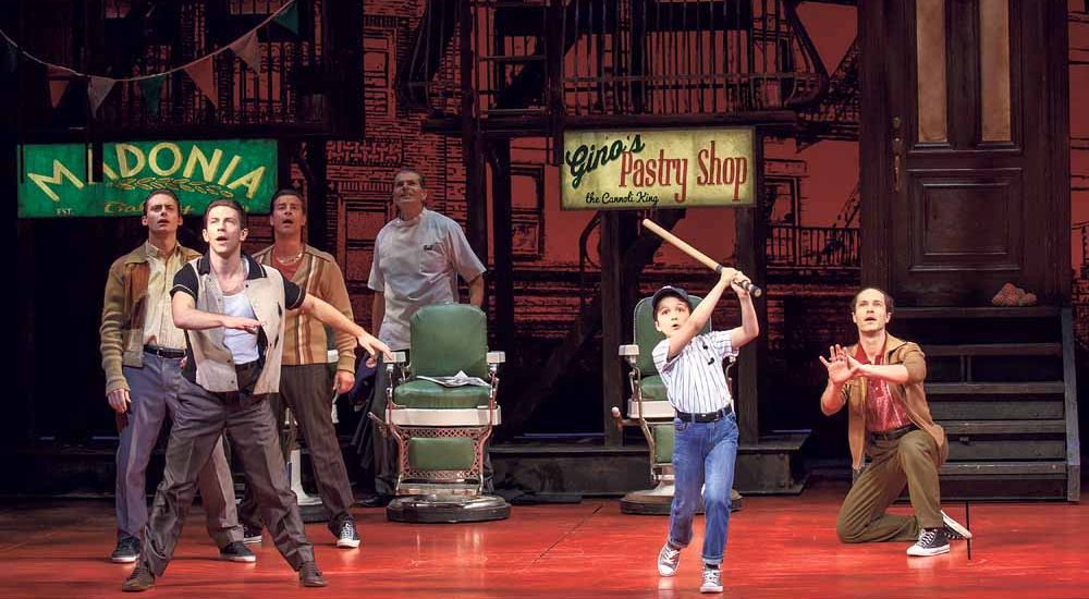  Young Calogero (Hudson Loverro) swings for the seats as A Bronx Tale cast looks on. (Photo by Joan Marcus) Theatre Owned / Operated by The Shubert Organization (Philip J. Smith: Chairman; Robert E. Wankel: President) Produced by Tommy Mottola, The Dodgers, Tribeca Productions, Evamere Entertainment, Neighborhood Films, Jeffrey Sine, Cohen Private Ventures and Grant Johnson; Produced in association with Paper Mill Playhouse (Mark S. Hoebee, Producing Artistic Director; Todd Schmidt, Managing Director); Associate Producer: Lauren Mitchell World Premiere in Millburn, New Jersey on February 14, 2016 at Paper Mill Playhouse (Mark S. Hoebee, Producing Artistic Director; Todd Schmidt, Managing Director) Book by Chazz Palminteri; Music by Alan Menken; Lyrics by Glenn Slater; Based on the play by Chazz Palminteri; Music arranged by Ron Melrose; Music orchestrated by Doug Besterman; Musical Director: Jonathan Smith Directed by Robert De Niro and Jerry Zaks; Choreographed by Sergio Trujillo; Associate Director: Stephen Edlund; Associate Choreographer: Marc Kimelman Scenic Design by Beowulf Boritt; Costume Design by William Ivey Long; Lighting Design by Howell Binkley; Sound Design by Gareth Owen; Hair and Wig Design by Paul Huntley; Makeup Design by Anne Ford-Coates; Associate Scenic Design: Jared Rutherford; Associate Costume Design: Mariah Hale; Associate Lighting Design: Ryan O'Gara; Associate Sound Design: Josh Liebert; Associate Hair and Wig Design: Giovanna Calabretta Executive Producer: Sally Campbell Morse; General Manager: Dodger Management Group; Company Manager: Miguel A. Ortiz; Associate Co. Mgr: Reeve Pierson Technical Supervisor: Hudson Theatrical Associates; Production Stage Manager: Beverly Jenkins; Stage Manager: Michael Rico Cohen Musical Supervisor: Ron Melrose; Musical Coordinator: John Miller; Conducted by Jonathan 'Smitti' Smith; Associate Conductor: John Samorian; Woodwinds: Kristy Norter and John De Simini; Trumpet/Flugel: Jami Dauber; Trombone/Tuba: Clint Sharman; Guitars: Kenny Brescia and Bernd Schoenhart; Drums: Perry Cavari;